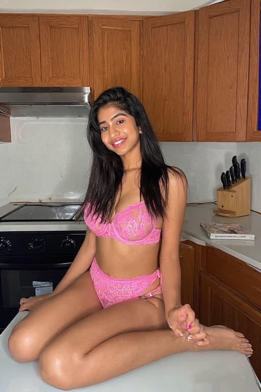 AI generated: photograph of sexy east 23-30 year old indian woman, sitting on kitchen counter, wearing pink lace l...