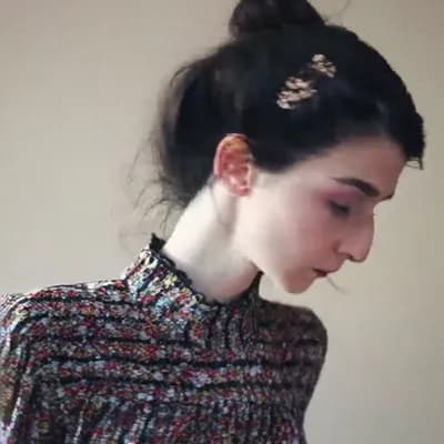AI generated video: she  removes her clothes instantly and is completely topless naked and reveals her big saggy breasts...