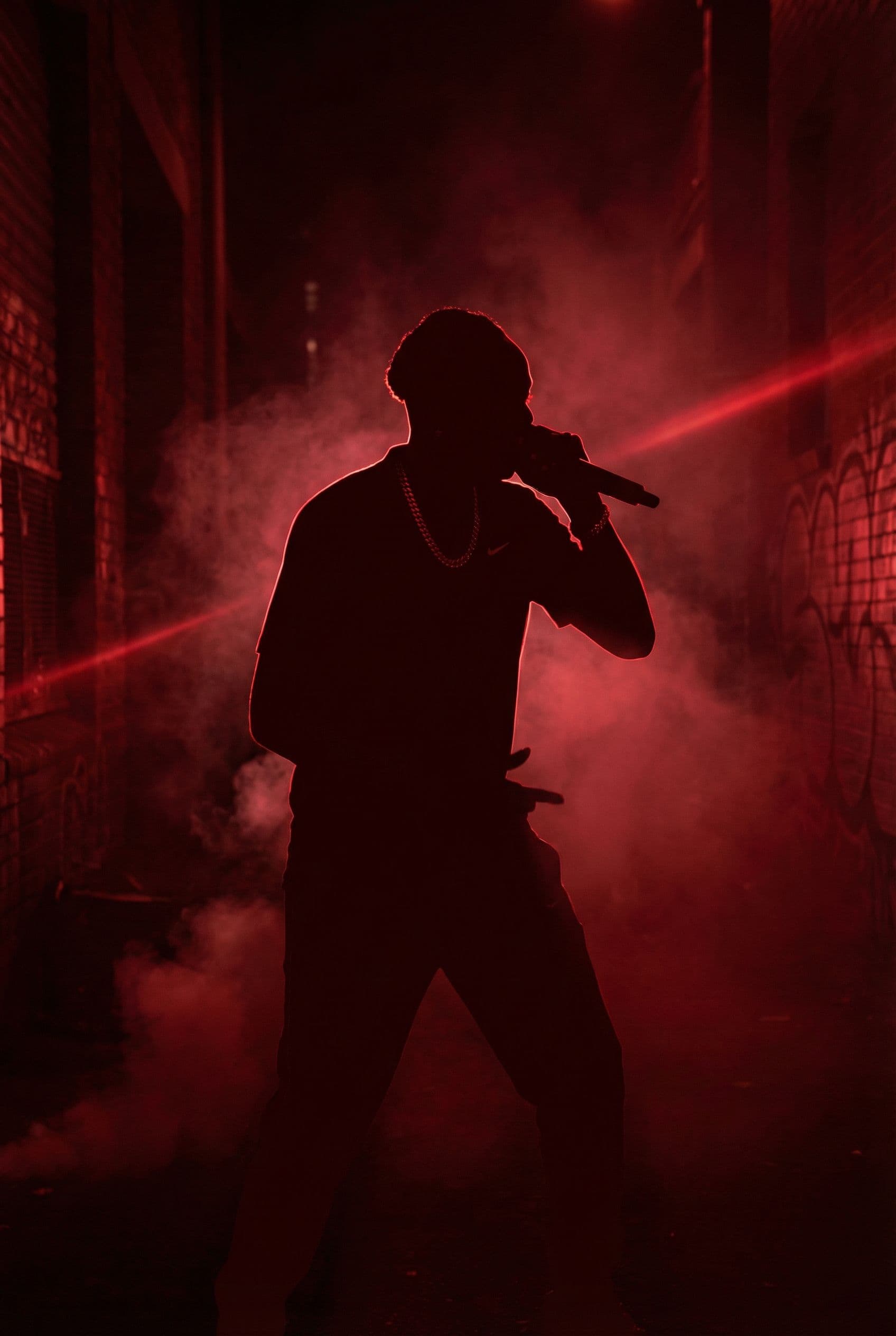 AI generated: A dark red silhouette scene for rap music video with the uploaded male picture 