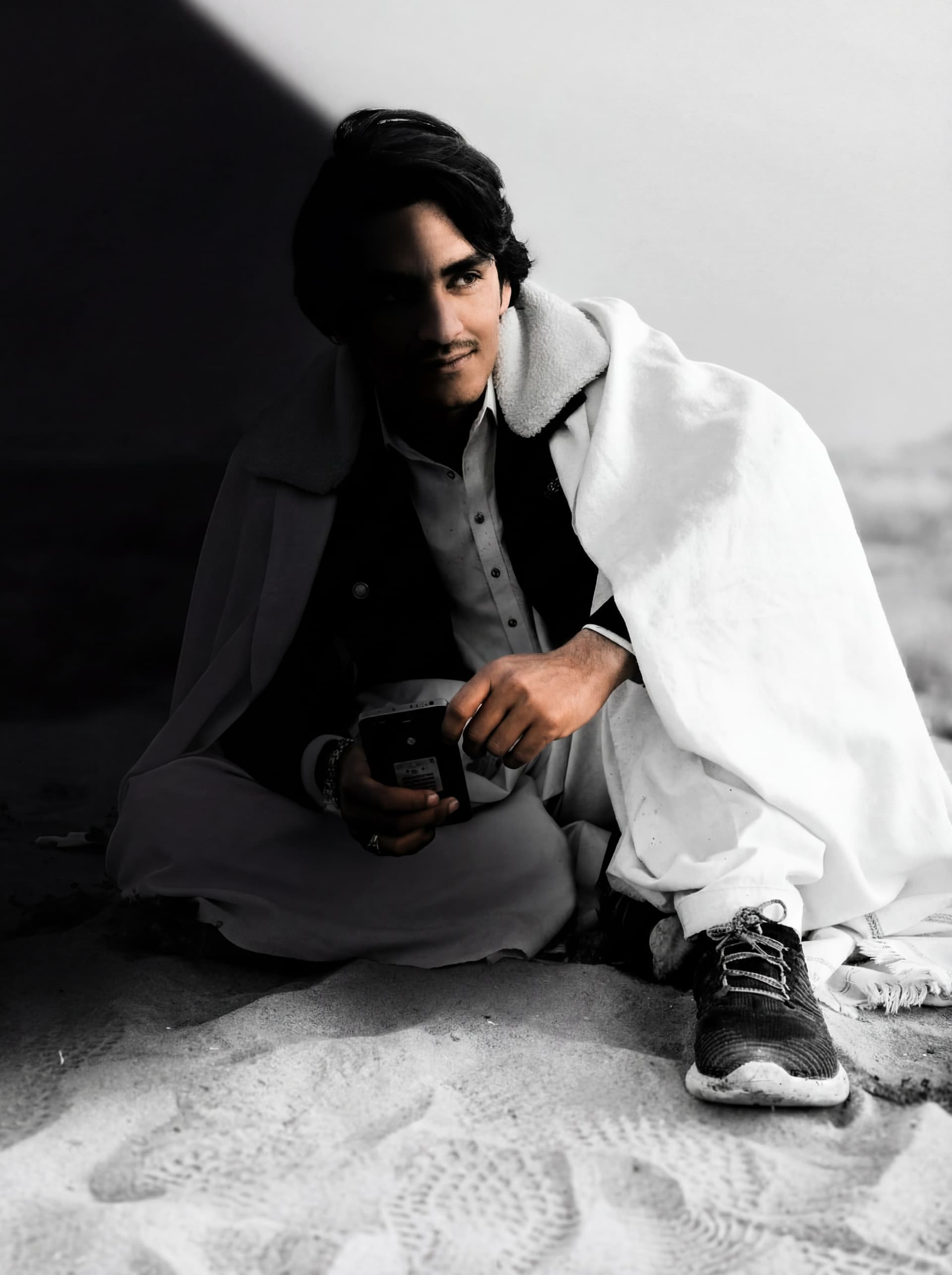 AI generated: a black and white photo of a man with shadow., in the style of minimalist beauty, light bronze and b...