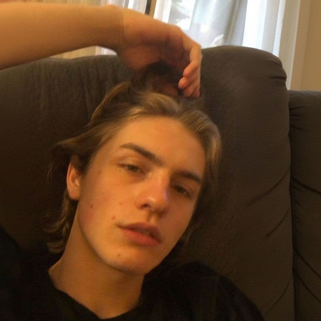AI generated: 16 blonde Russian boy

* **Subject:** The image is a close-up portrait of a young man with medium-...