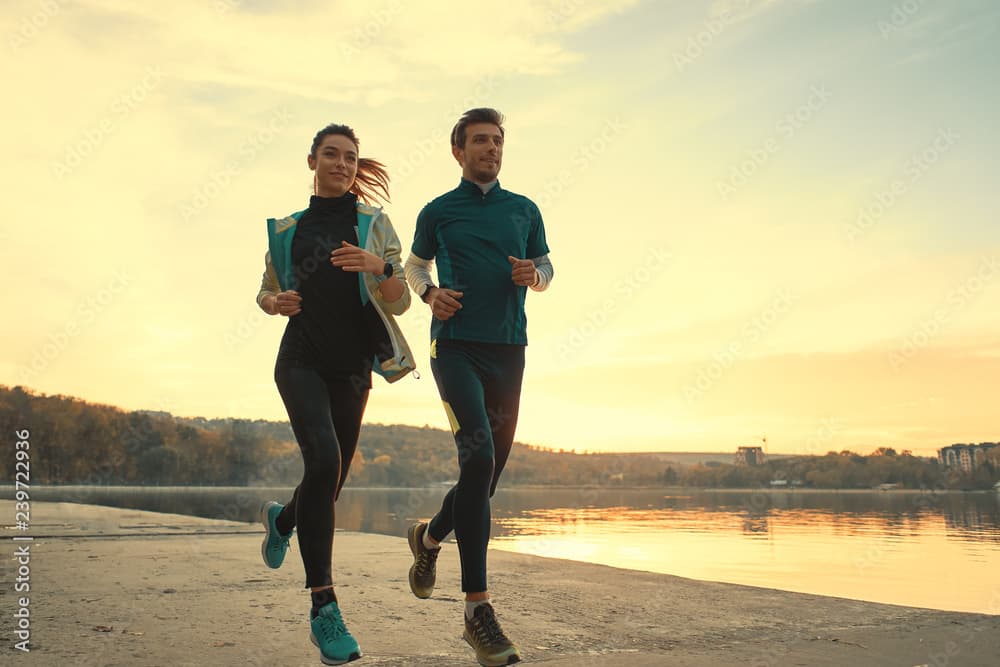 AI generated: Highly realistic photo of man and woman running, dramatic light, pale sunrise, running, 4k, highly r...