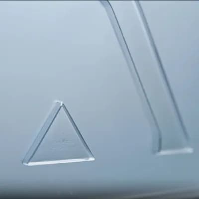 AI generated video: create a lateral (left to right) dolly camera animation focusing only on the triangle. The surface a...