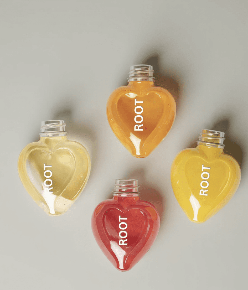 AI generated: make the bottles in this picture as this: A  heart-shaped glass bottles are lying on a surface. The ...