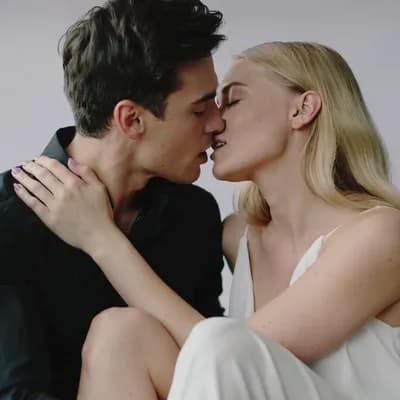 AI generated video: The two models curl up and share a passionate kiss 