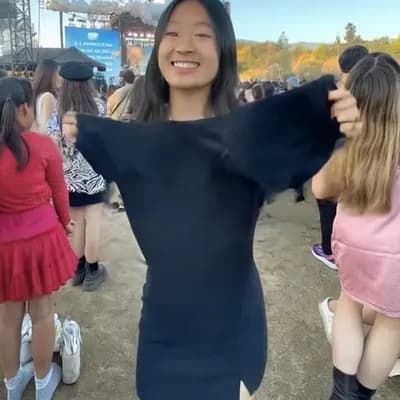 AI generated video: She takes her top off, revealing perfect breasts. She jumps around while turning around, taking off ...