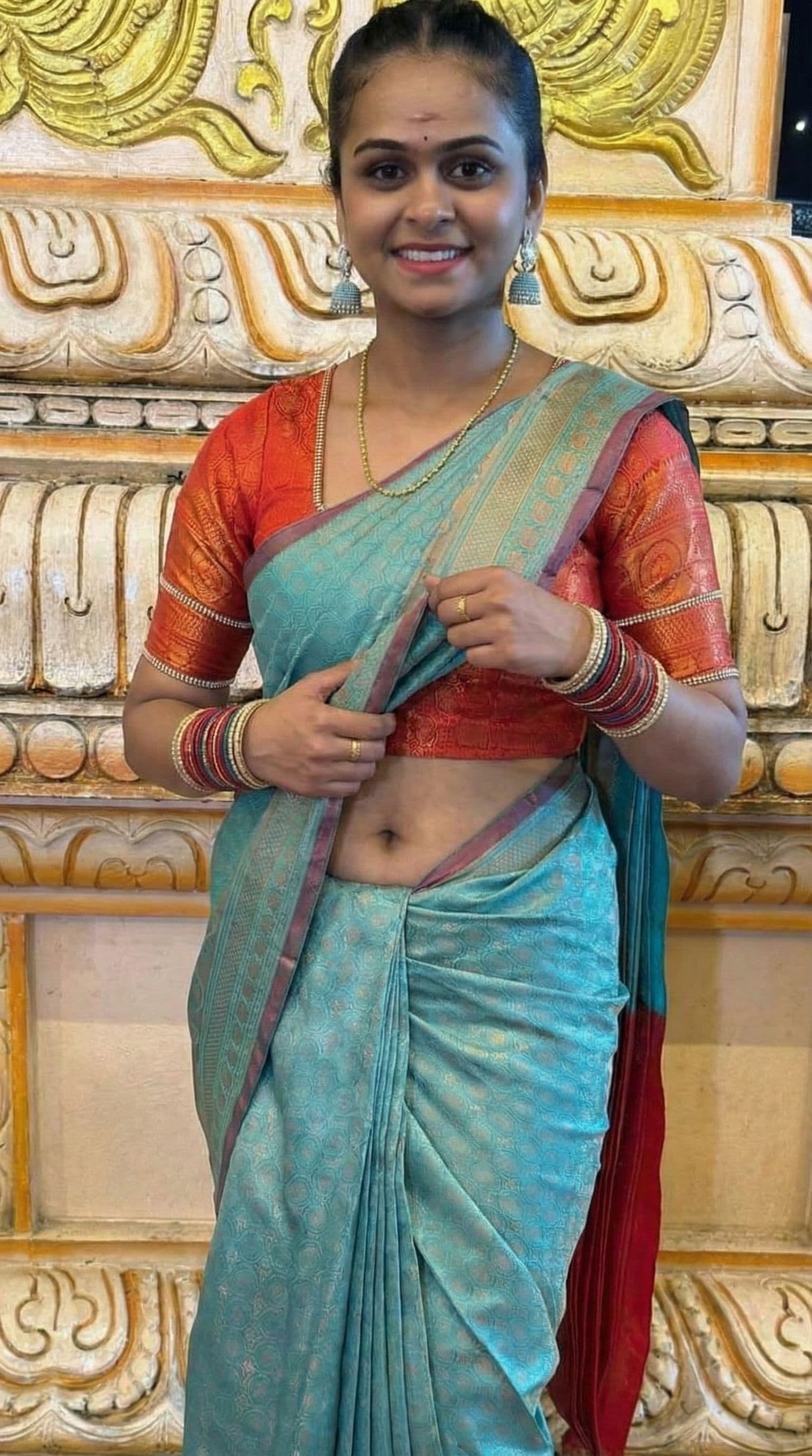 AI generated: Showing navel by lifting up top saree
