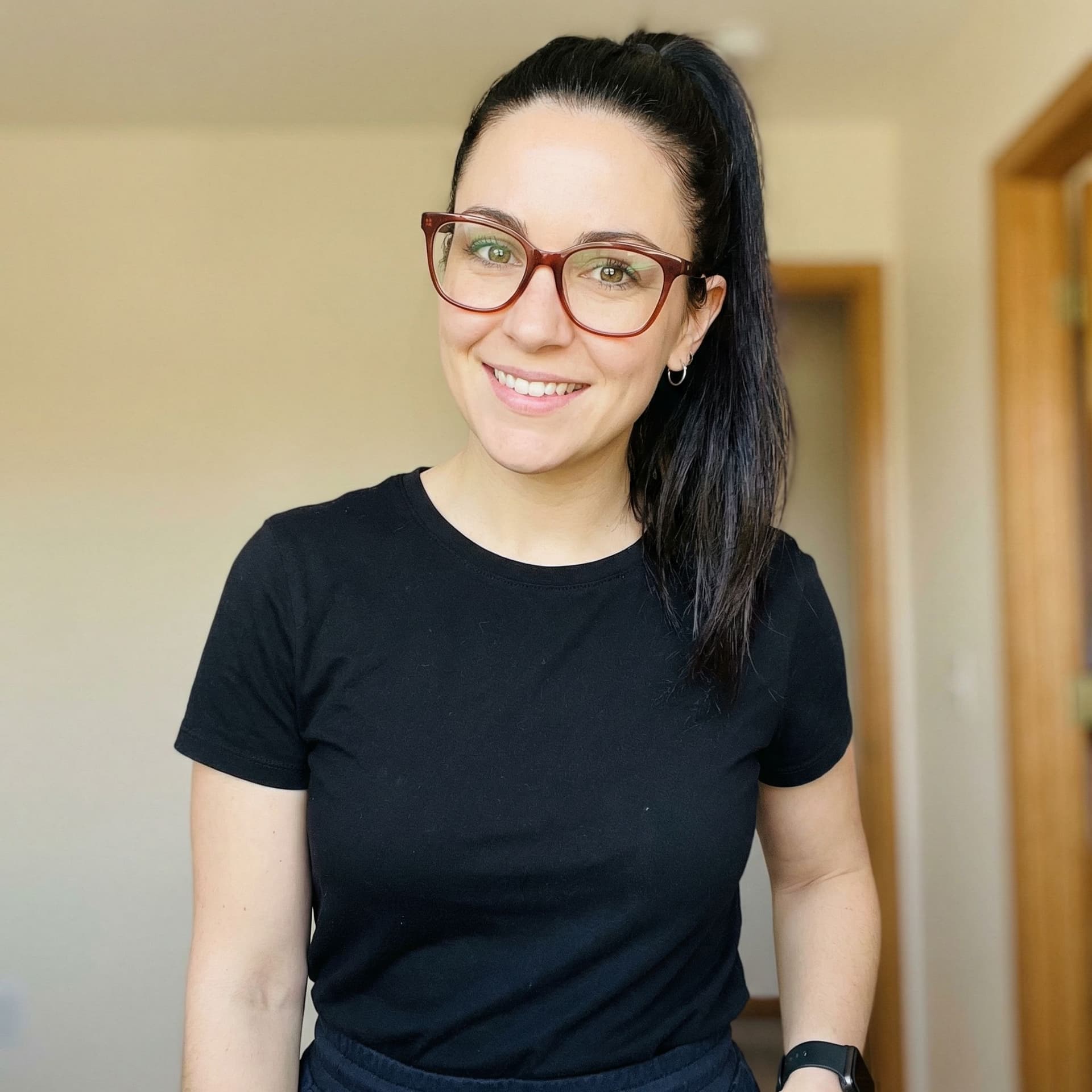 AI generated: A woman with dark hair styled in a high ponytail is shown from the chest up, looking towards the cam...