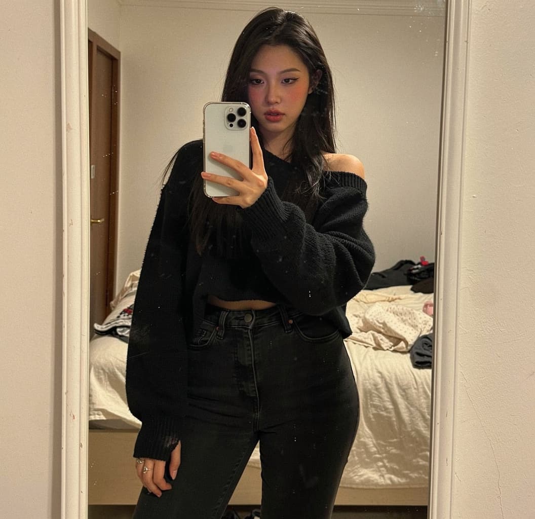 AI generated: A realistic mirror selfie of a cute asian e-girl, 20 y.o., taken with iPhone white 16 Pro Max held i...
