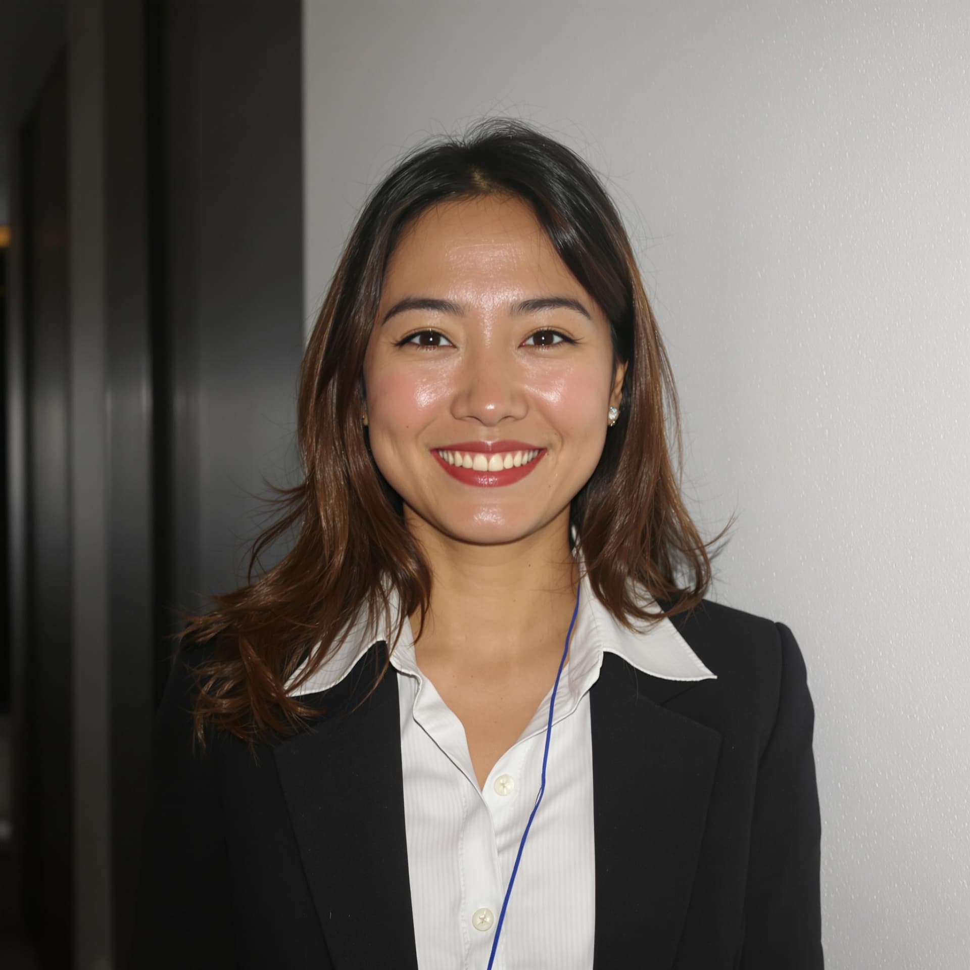 AI generated: asian woman in business professional attire, white wall