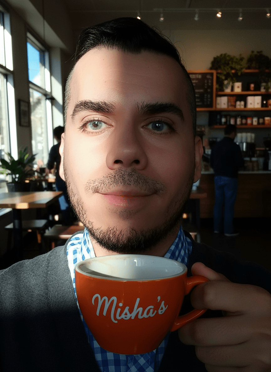 AI generated: The guy has blue eyes. He is at a coffee shop. He is grabbing his orange coffee cup. The cup says on...