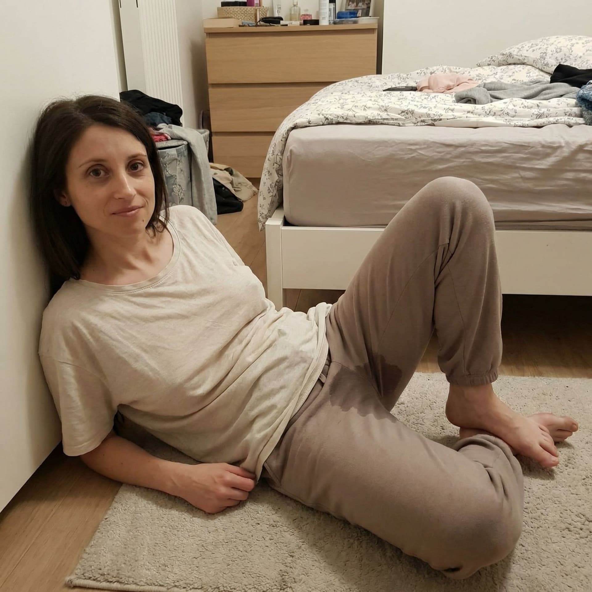 AI generated: laying on the corner of her room, her legs revealing her wet clit. her breasts are natural and saggy