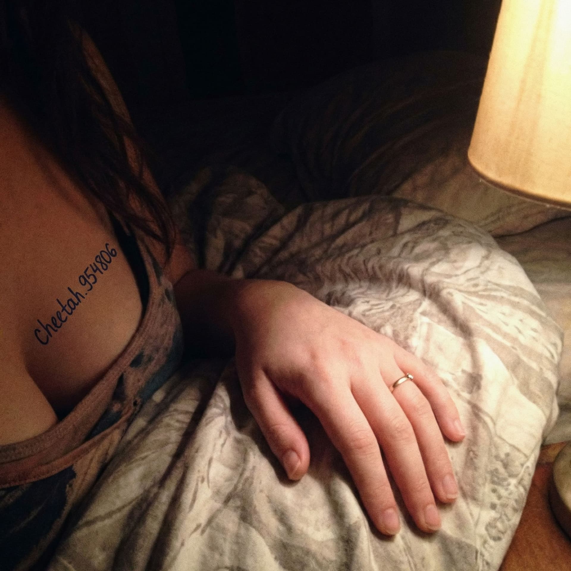 AI generated: A close-up of the hand of a 26-year-old woman with fair skin, resting on a crumpled bedsheet. Only h...