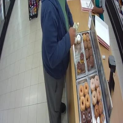 AI generated video: a hyper realistic fat man is buying donuts at a store and a security camera films him