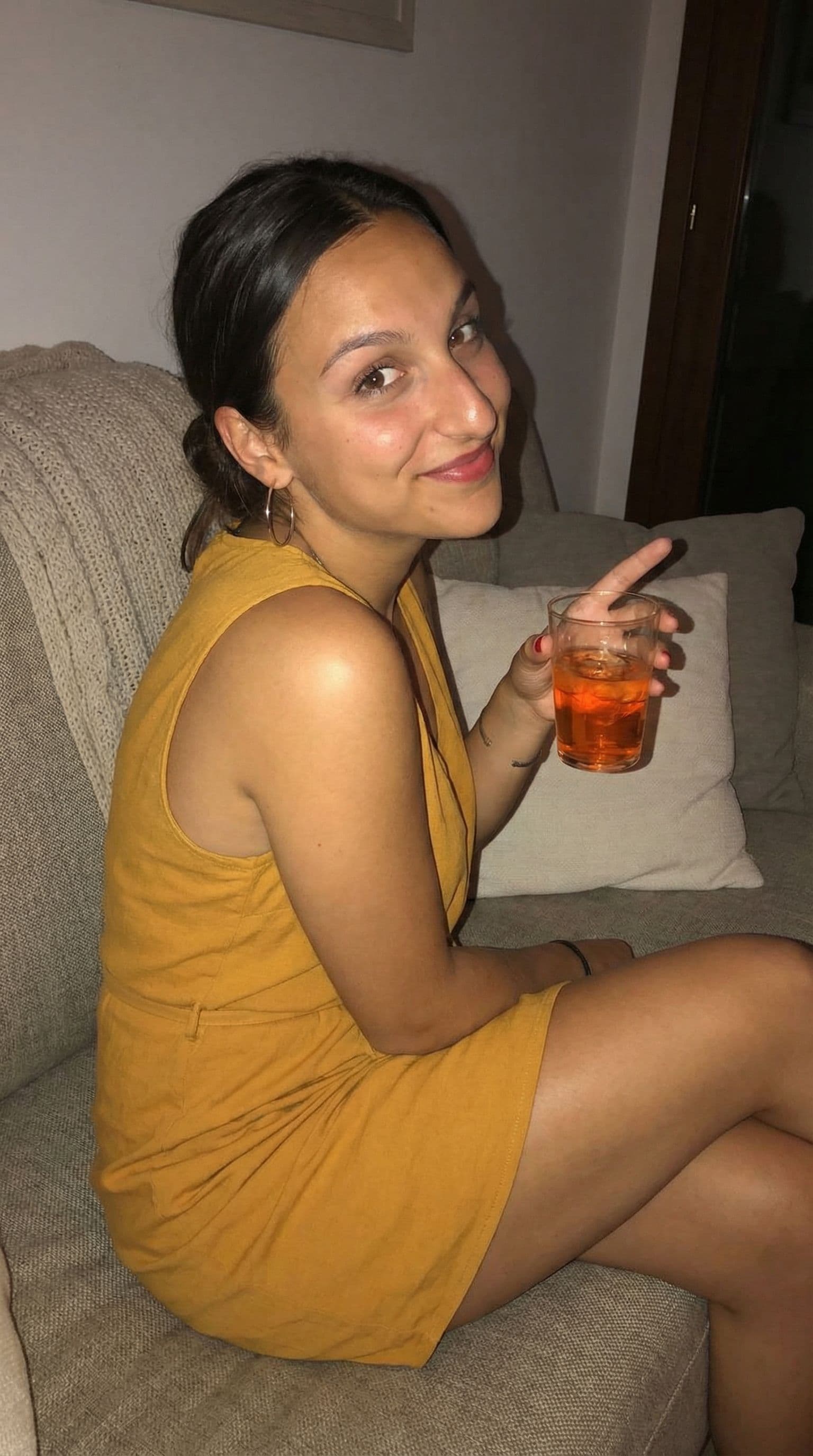 AI generated: Wearing a mini dress, sitting on a couch, teasing, close view, 35-year-old , busty body, 