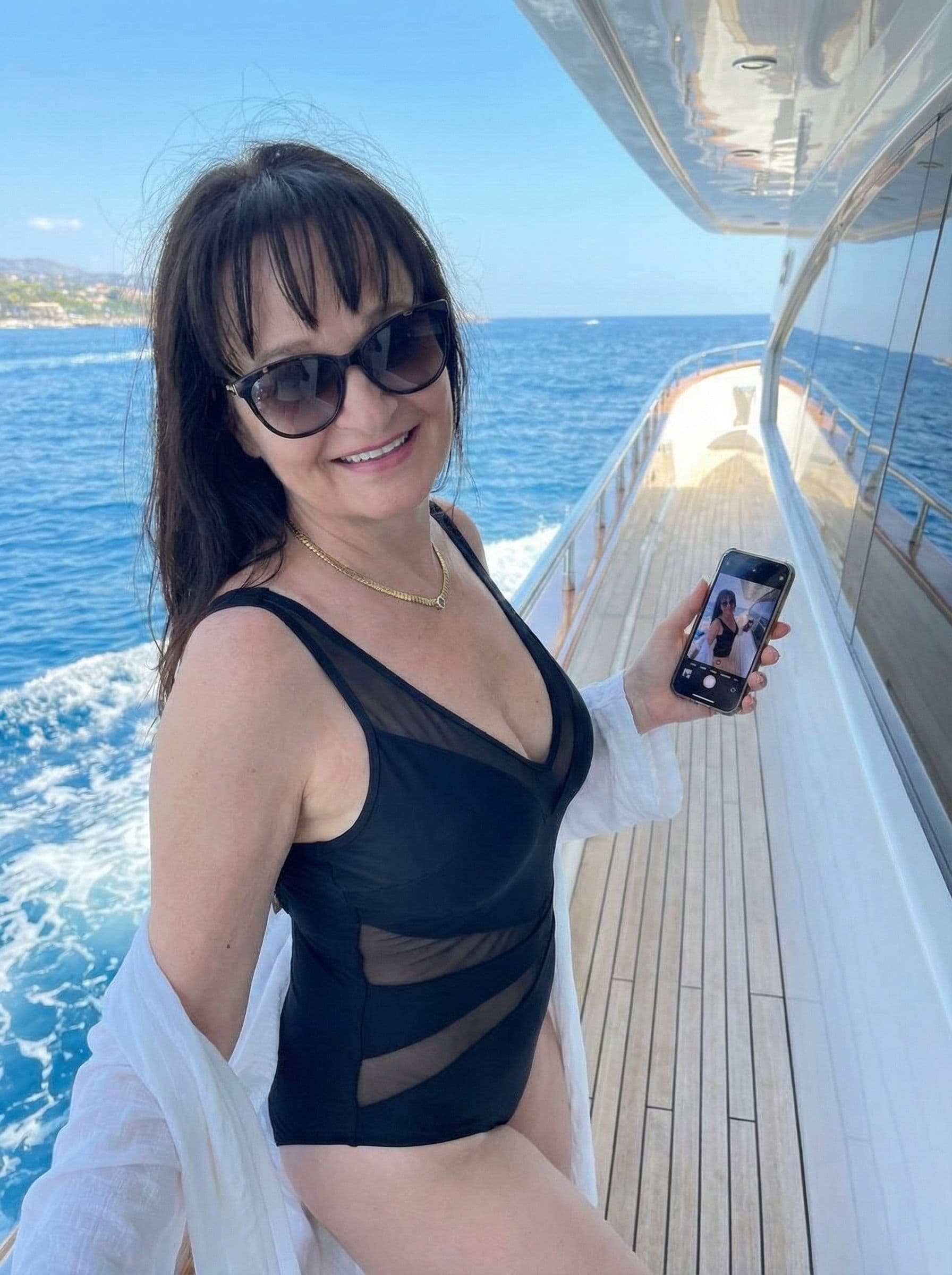 AI generated: The uploaded woman posing on a luxury yacht, stylish swimwear, ocean waves in the background, glamor...