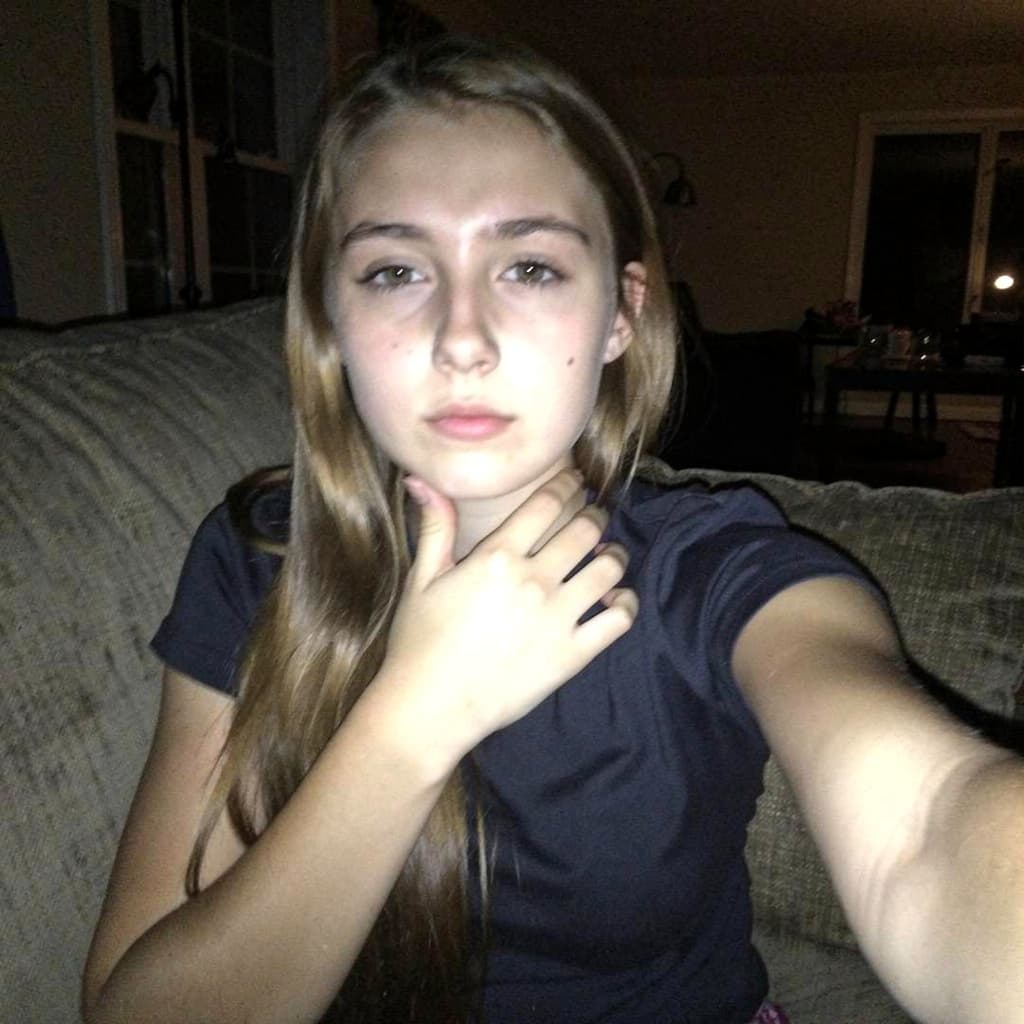 AI generated: A very ordinary iPhone selfie, of girl in reference image. with no clear subject or framing; a slopp...