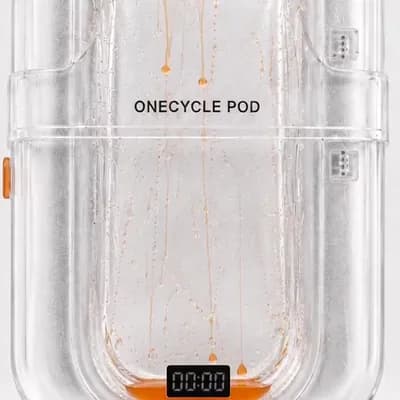 AI generated video: Animate only the tiny liquid orange droplets inside the transparent ONECYCLE POD. Keep the pod, labe...