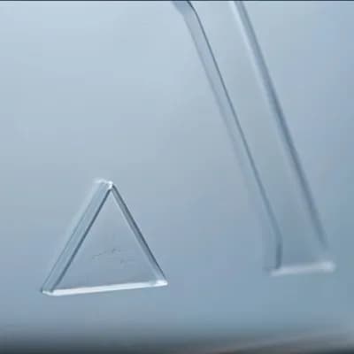 AI generated video: create a lateral dolly camera animation focusing only on the triangle. The surface appears smooth, f...