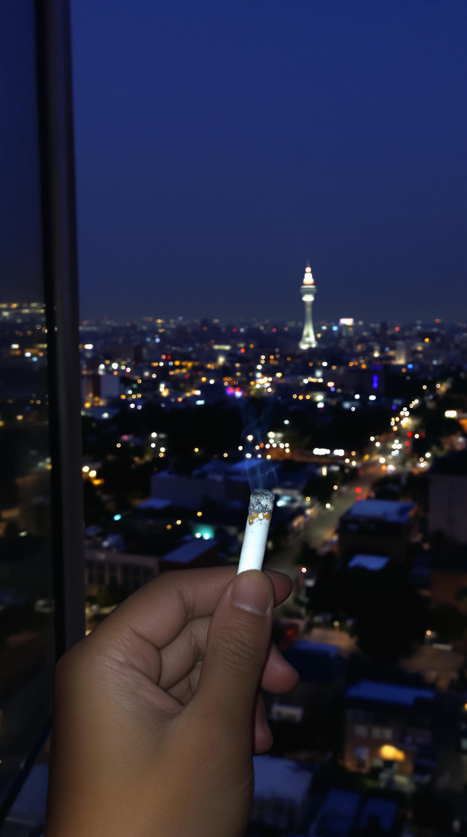 AI generated: POV first-person, I'm standing by the open window, smoking a cigarette. Only my hand and the cigaret...