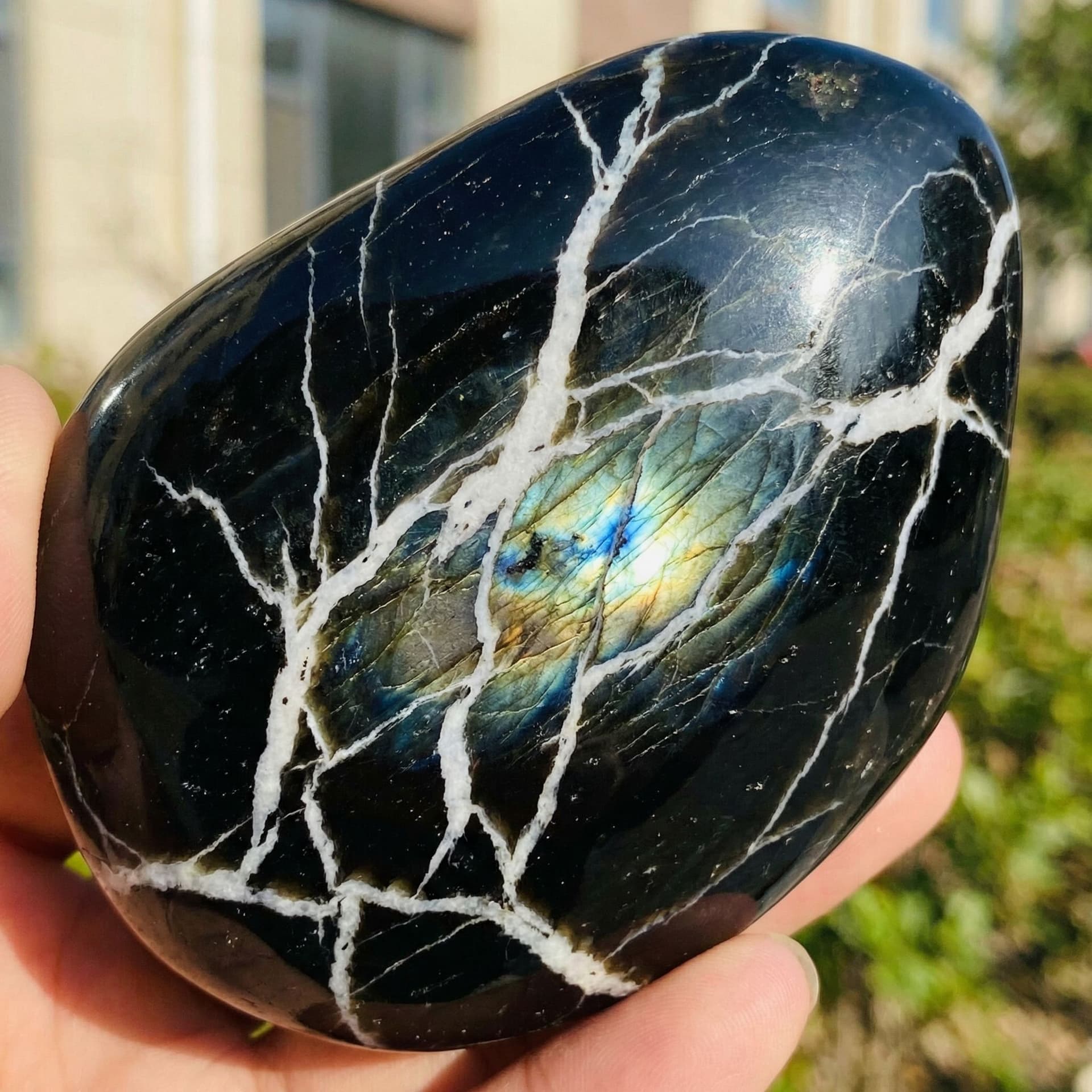 AI generated: Black obsidian with white veins flowing through it like lightening and it has a shine like Labradori...
