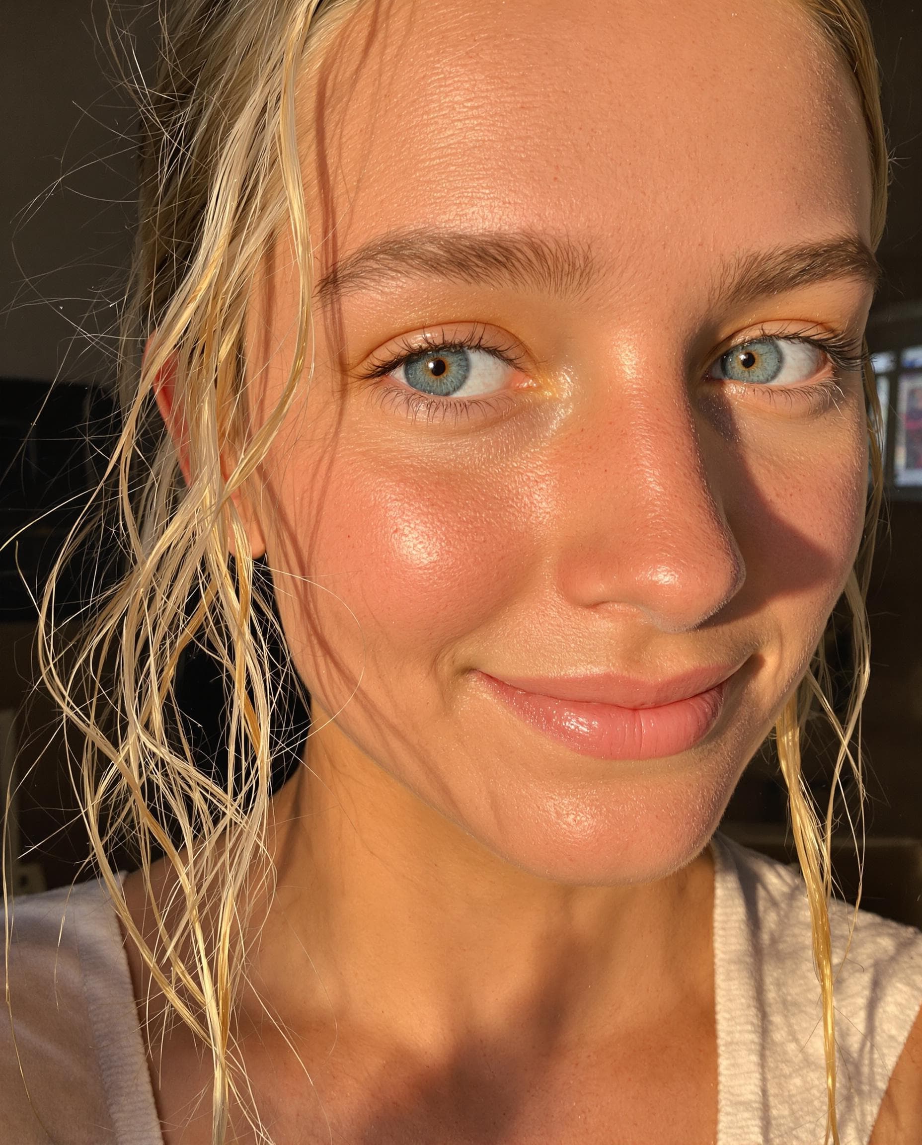 AI generated: low quality phone photo, snapchat, a semi close-up of a girl's face with light blue eye's, wavy blon...