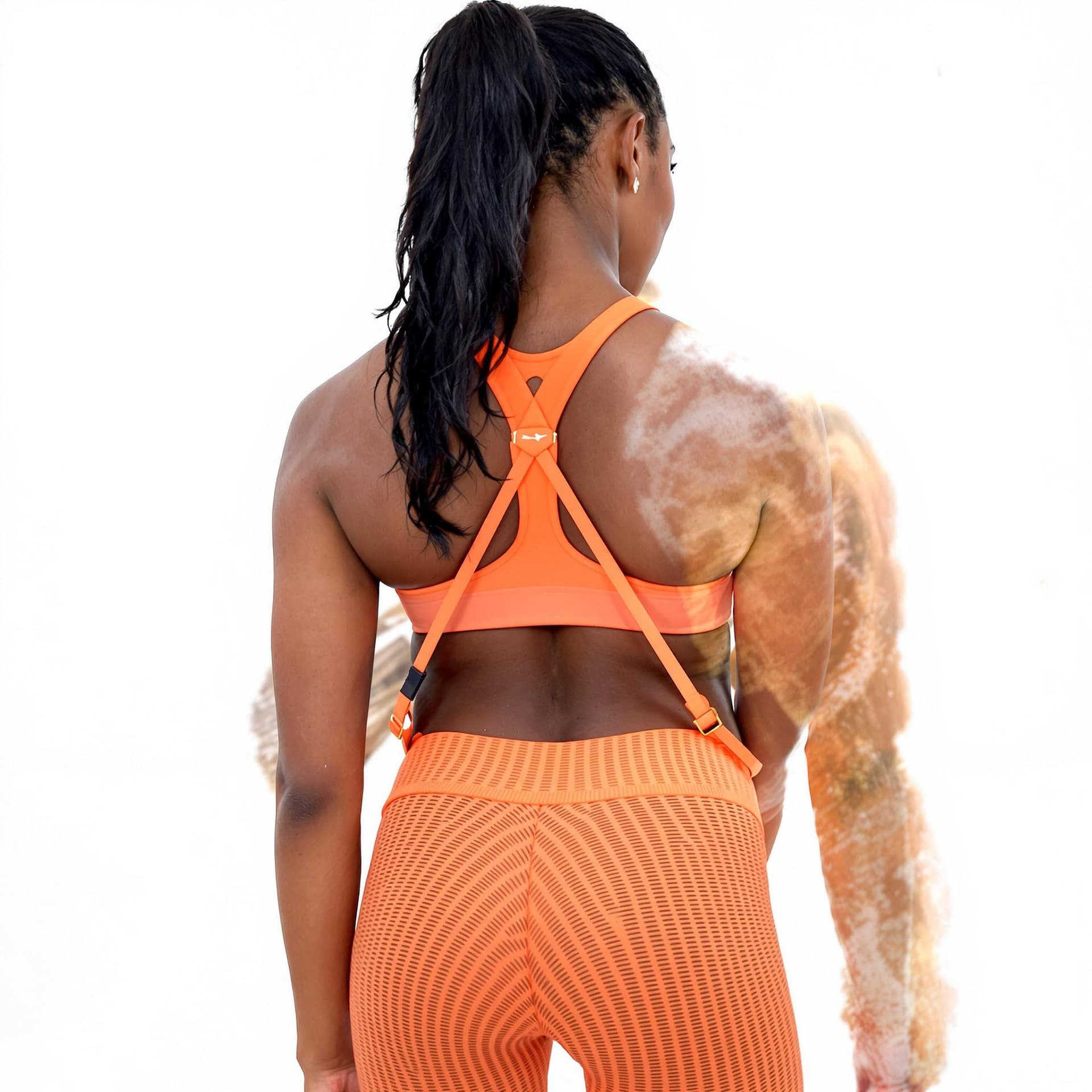 AI generated: a  black woman wearing orange sports bra and matching leggings. Her hair is pulled back in a ponytai...