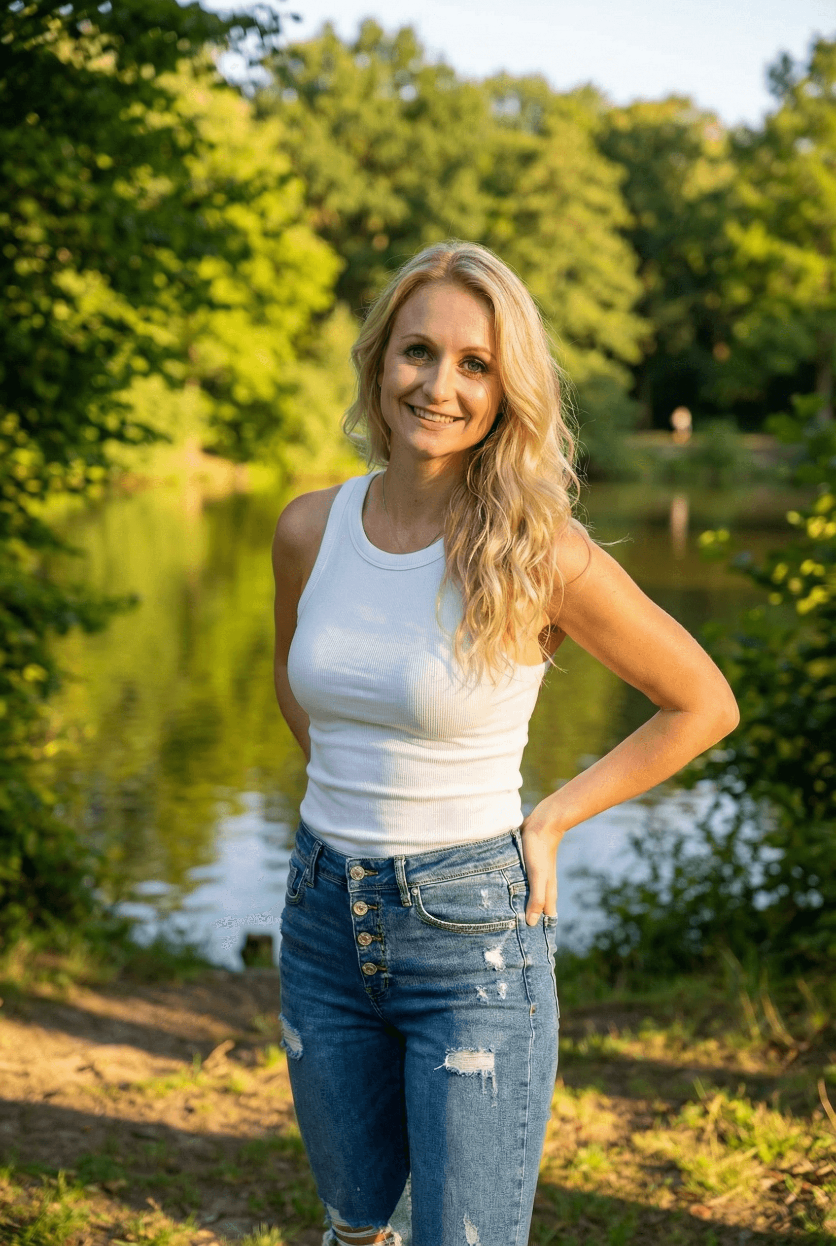 AI generated: A fit adult woman stands in a sunlit outdoor setting, facing the camera, her hands resting casually ...