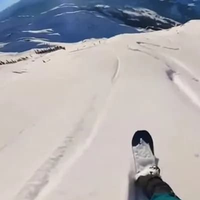 AI generated video: a first-person GoPro video of a snowboarder descending from a mountain 
