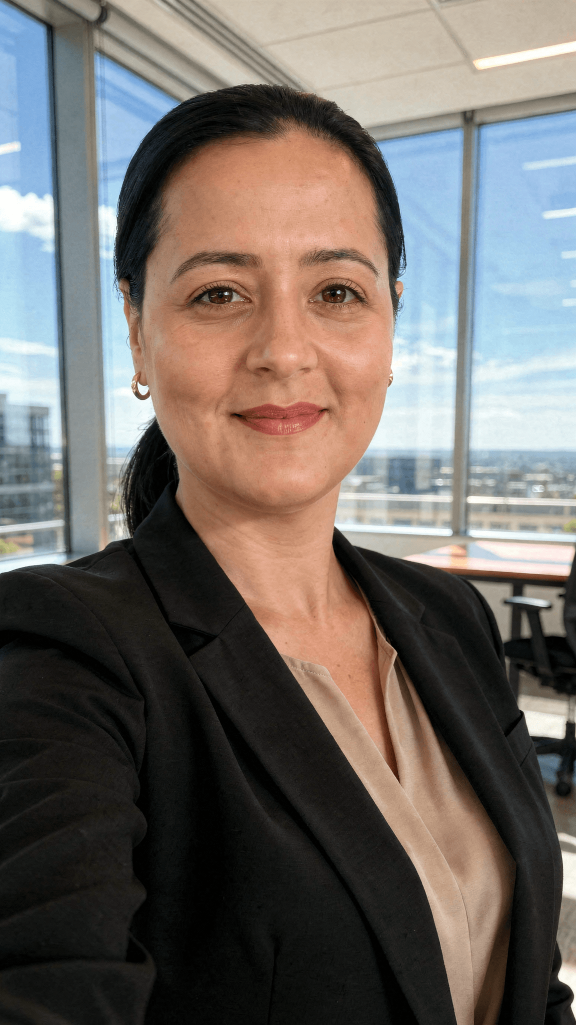 AI generated: generate a LinkedIn professional profile photo, wearing a beautiful black blazer, beautiful office s...