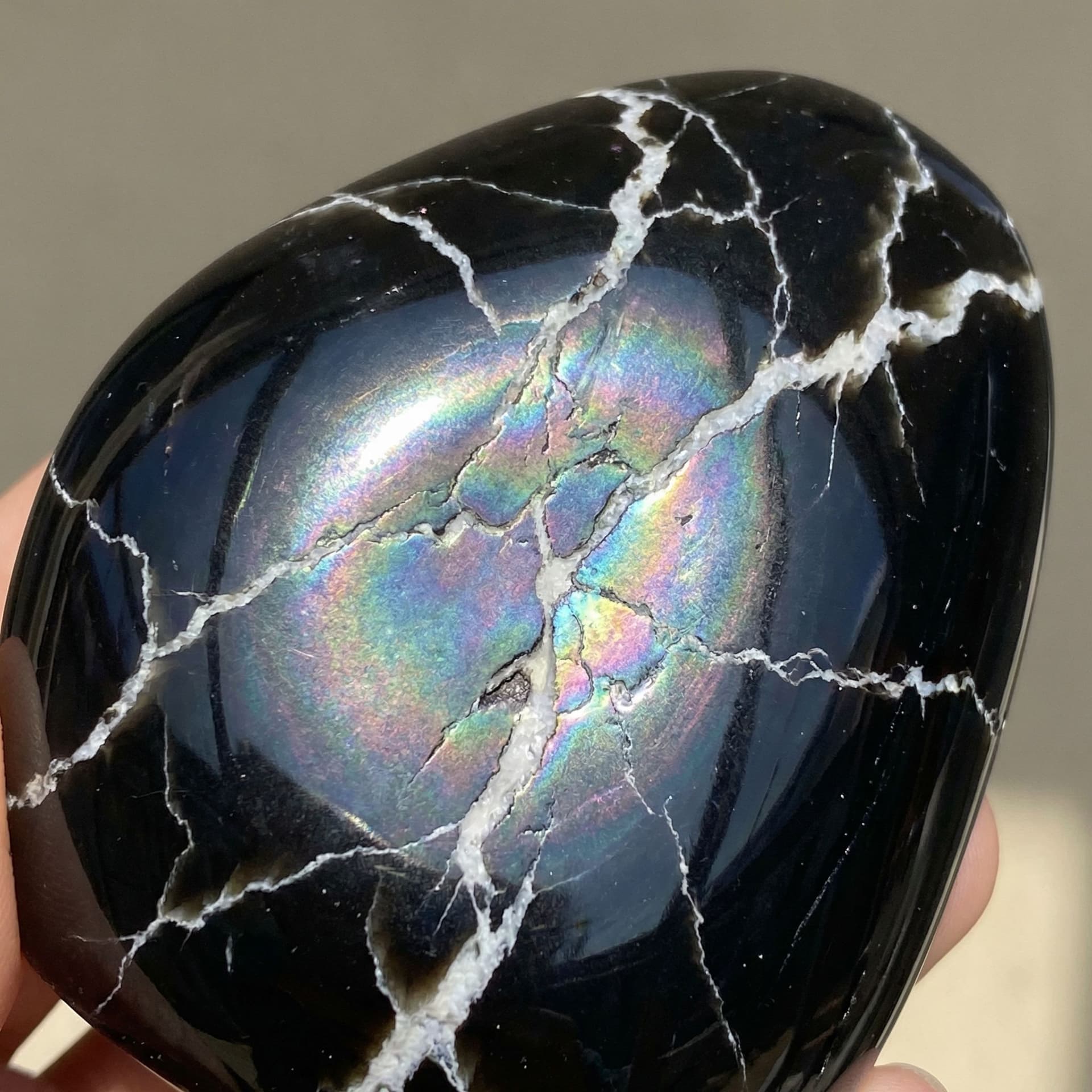 AI generated: Black obsidian with white veins flowing through it like lightening and it has a shine like opal