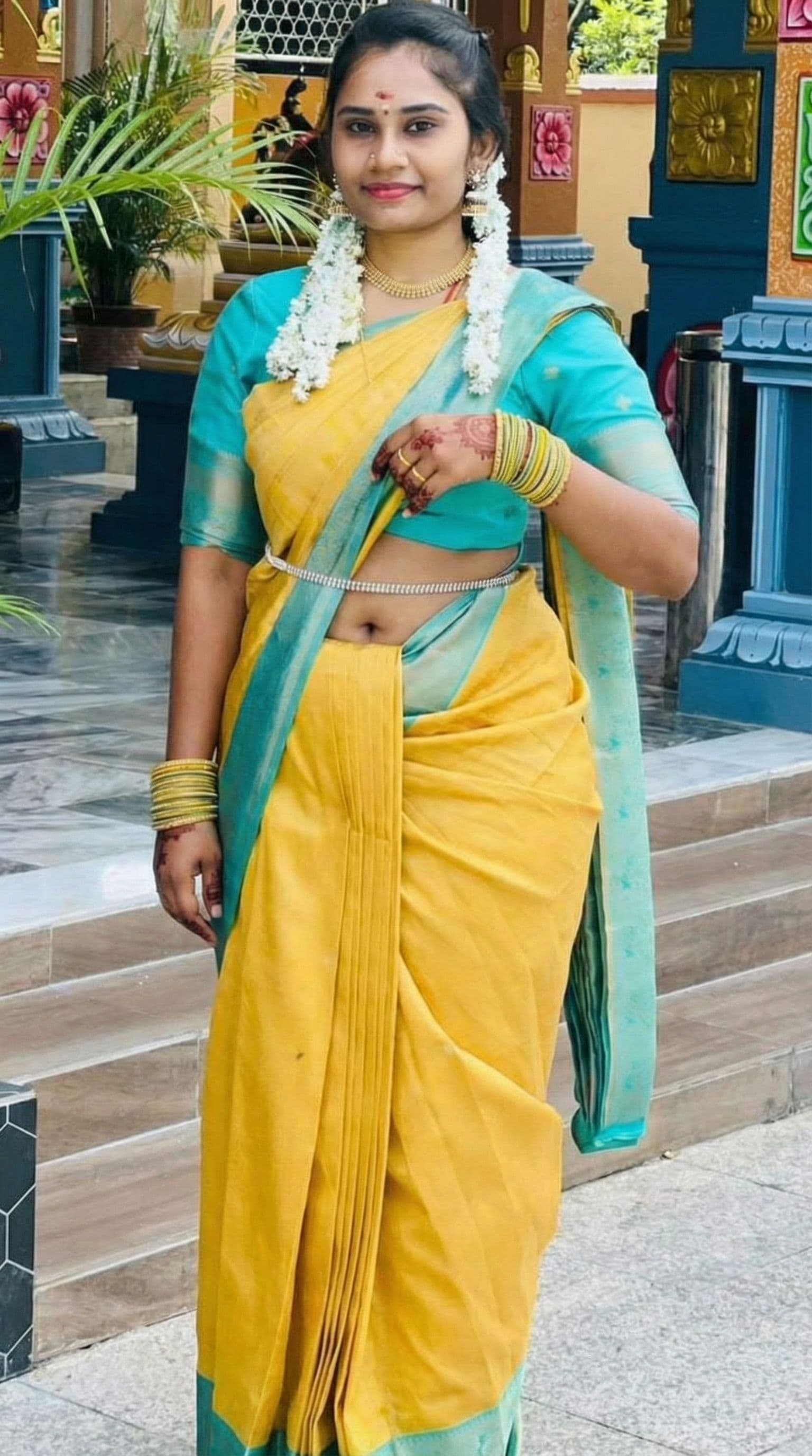 AI generated: Showing navel by lifting up top saree