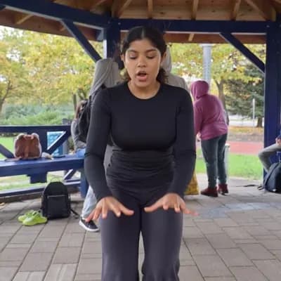 AI generated video: The girl in black bends down and picks up a pencil