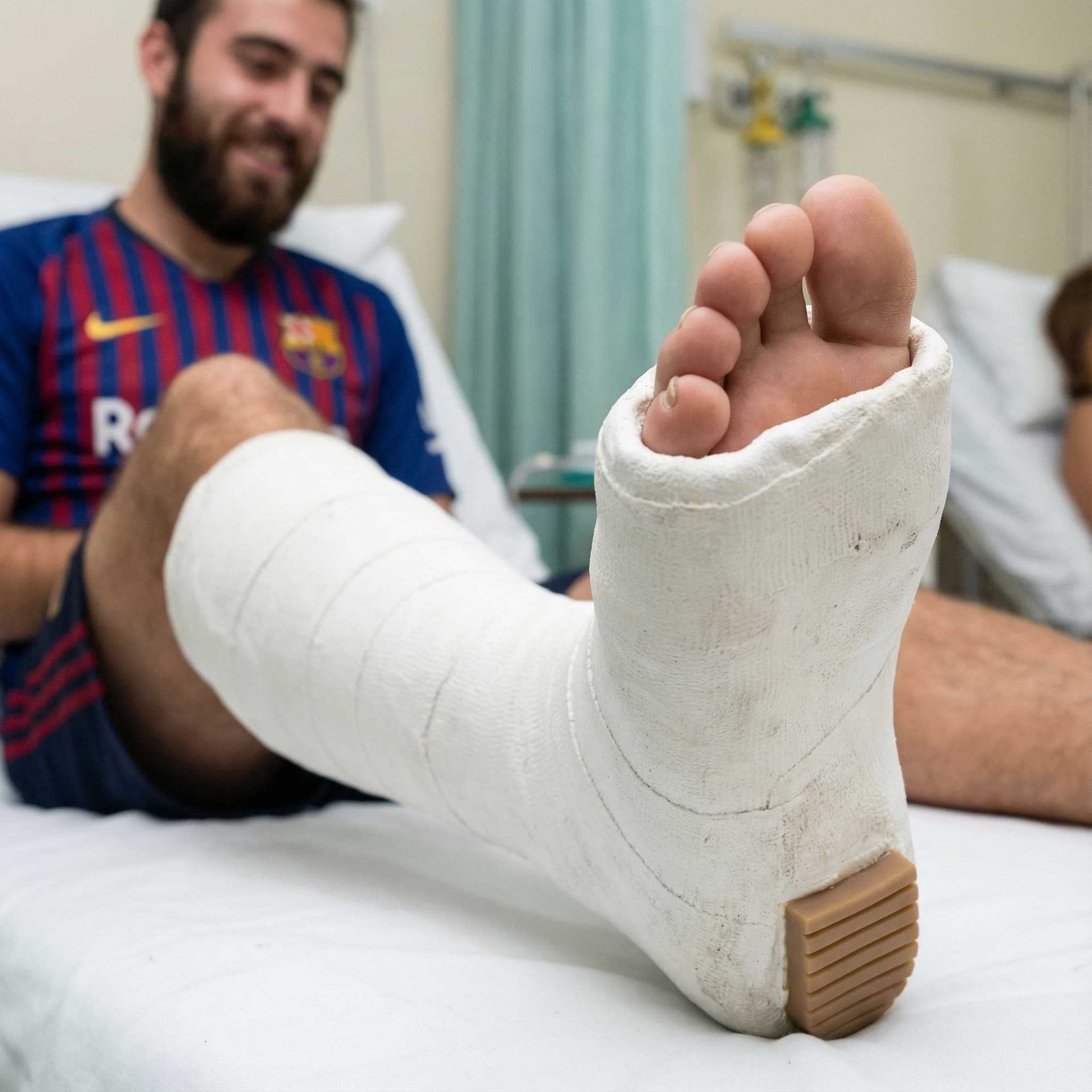 AI generated: Image of a thick leg cast in plaster with a small heel underneath the foot on a young turkish bearde...