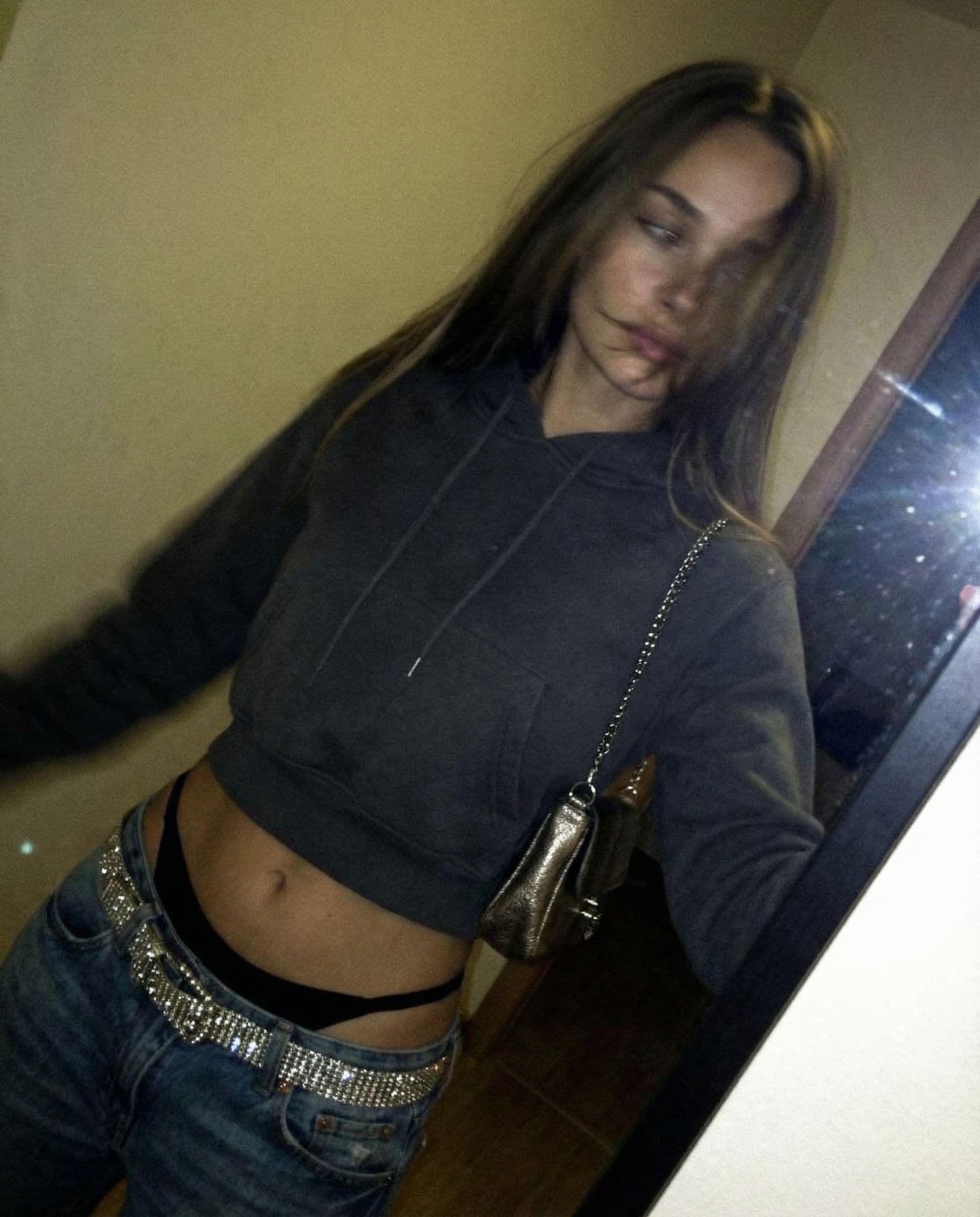 AI generated: a lo-fi 2015s-era, diagonally taken, low-quality iPhone photo of a 20-year-old baddie. The shot is i...