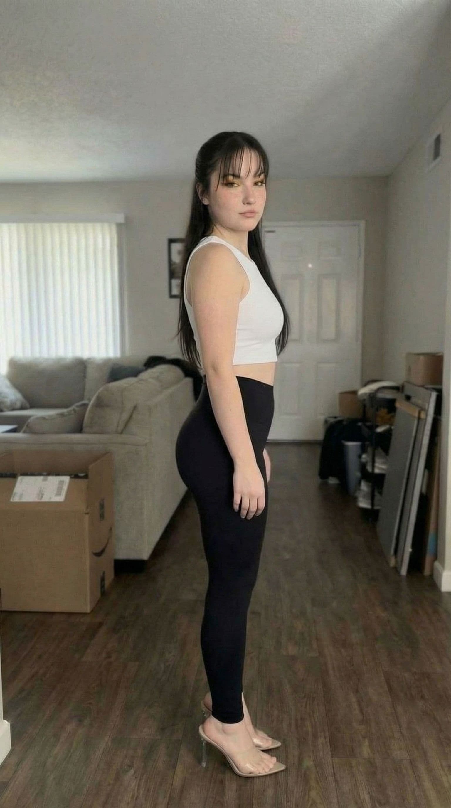 AI generated: give her a bubble butt, do not alter her face, keep original face, make heels square toe and not poi...