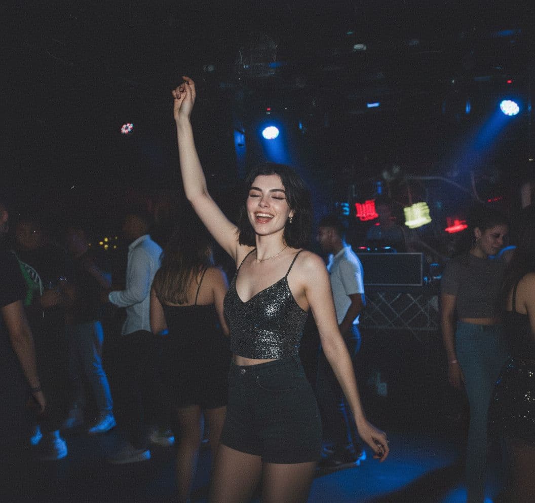 AI generated: a Grainy disposable camera photo in a club in her clubbing outfit remove her accessories and add a b...