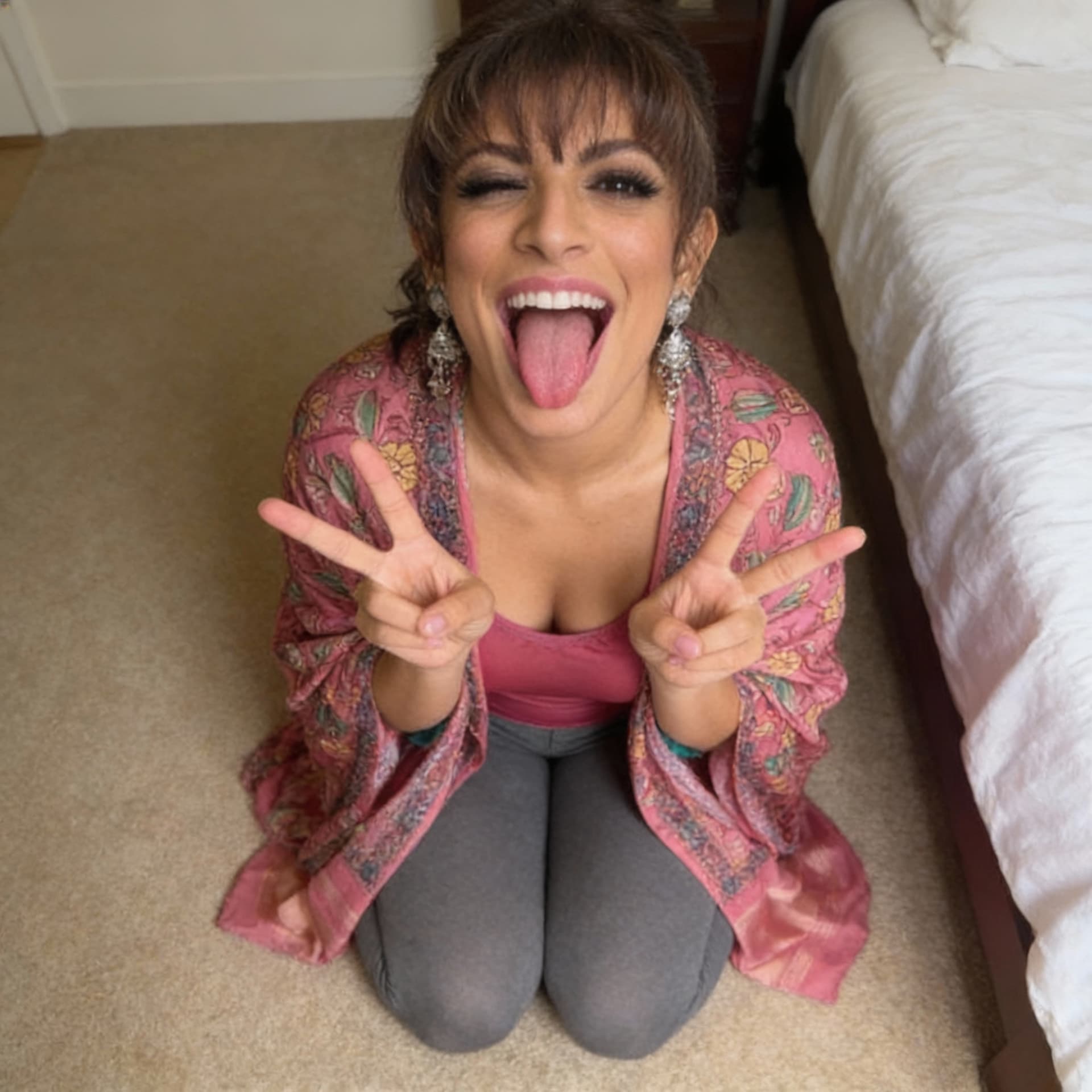 AI generated: Sitting on her knees on the bedroom floor, Stick my tongue out with my mouth wide open with my eyes ...