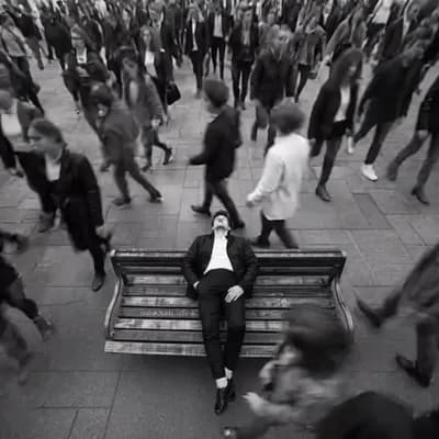 AI generated video: Cinematic black and white scene of a crowded city street viewed from above, hundreds of people rushi...