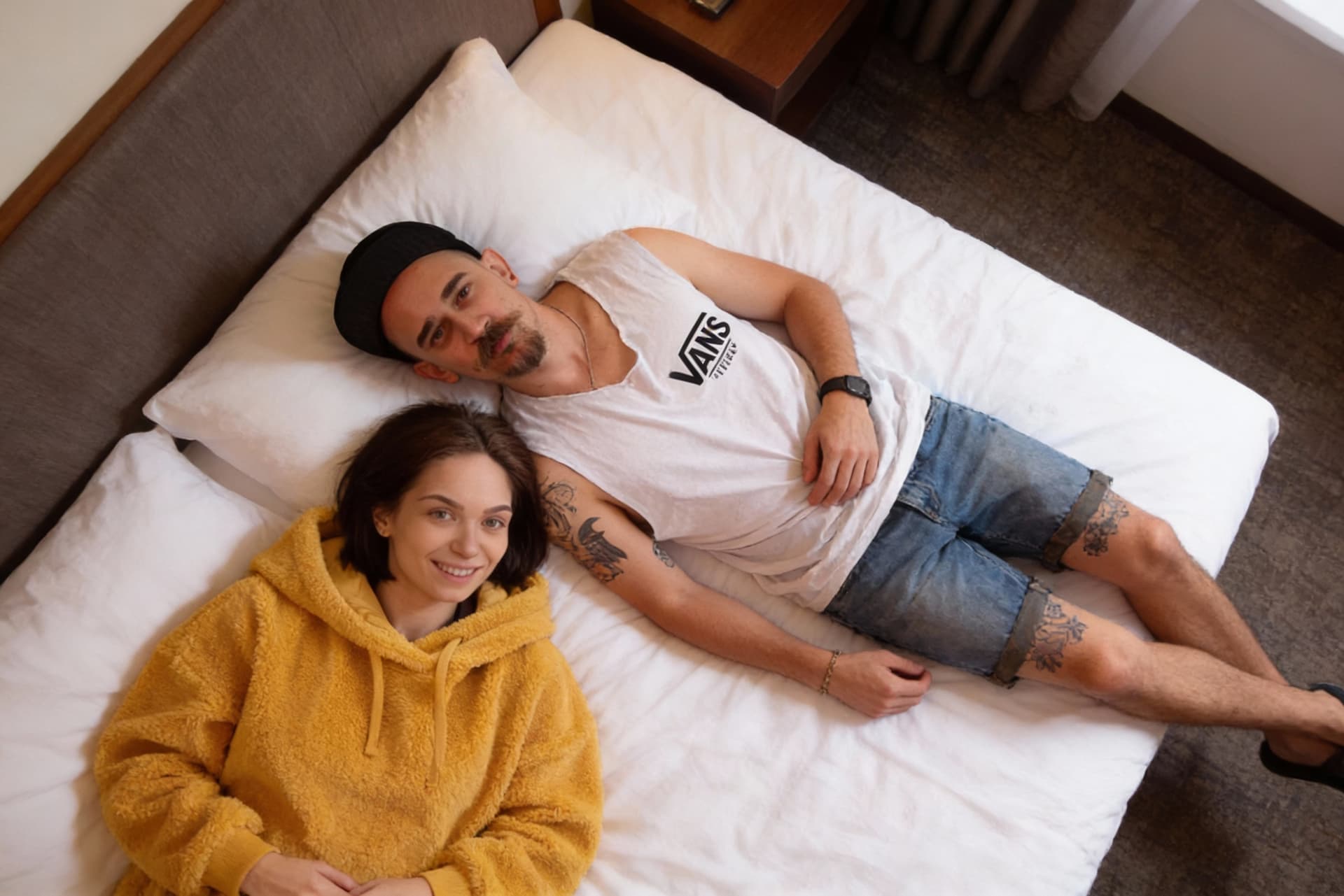 AI generated: there are 2 ppl on reference photos. me and my girlfriend unite us on one photo in a bed on hotel ro...