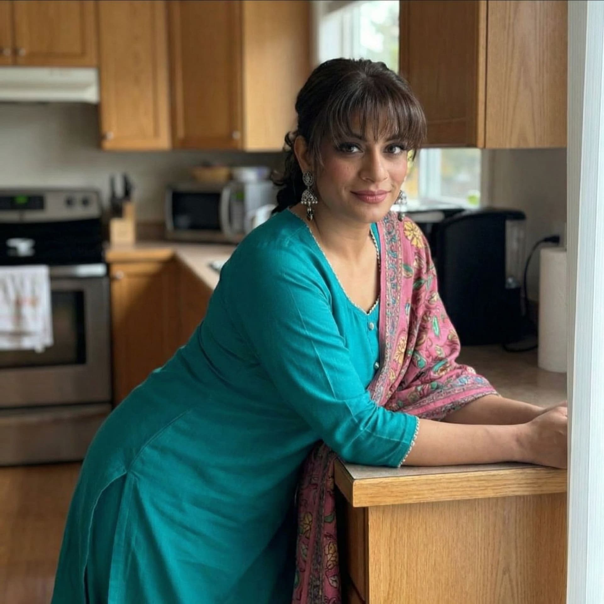 AI generated: Seductive, leans over on a kitchen desk, front view,