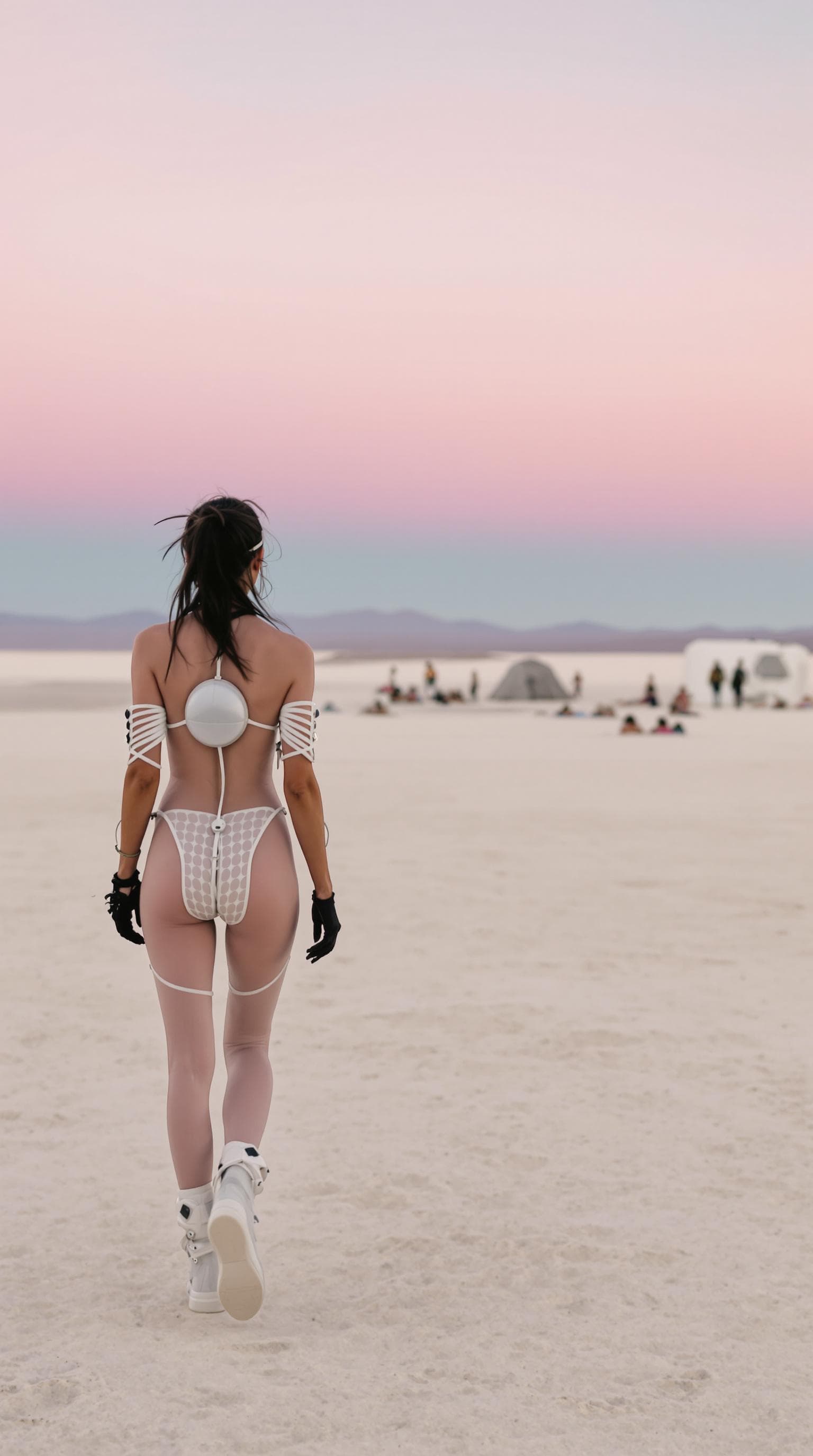 AI generated: The image features a person walking away in a striking landscape. The individual is dressed in a min...