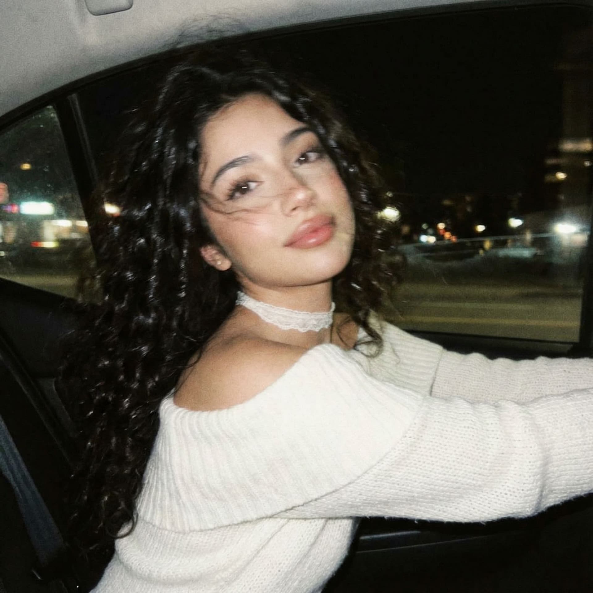 AI generated: Create a photo of me leaning my back out the window car like a dark dreamy blurry vintage windy

nig...