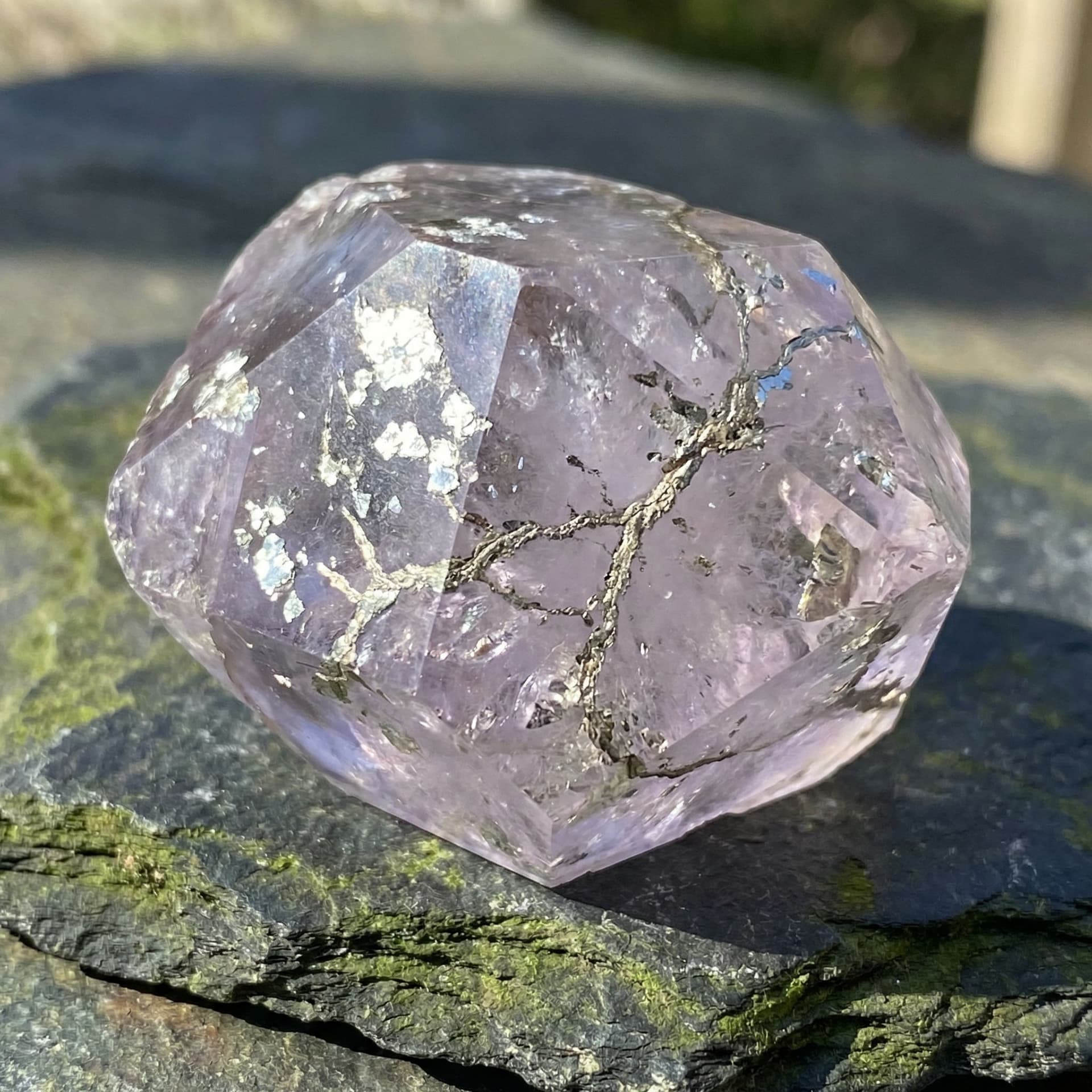 AI generated: A clear crystal with a purple tint and flakes of silver in it and veins that look like platinum