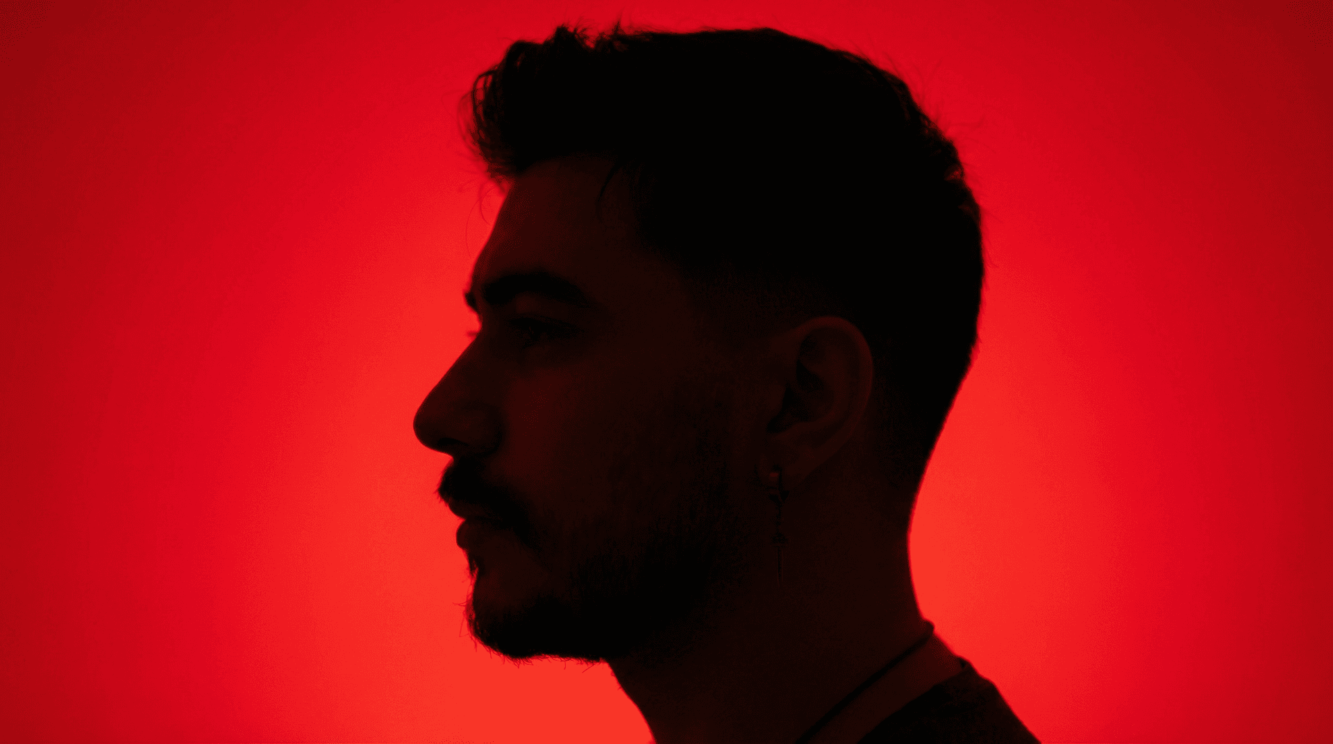 AI generated: photography, portrait of contrast, profile silhouette of a man, vibrant red backdrop, visualize usin...