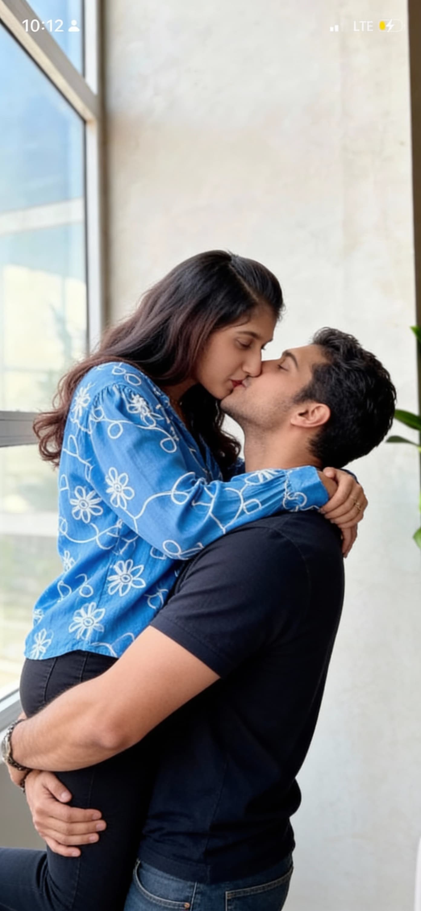 AI generated: The man lifting the women on his arms and kissing the lips