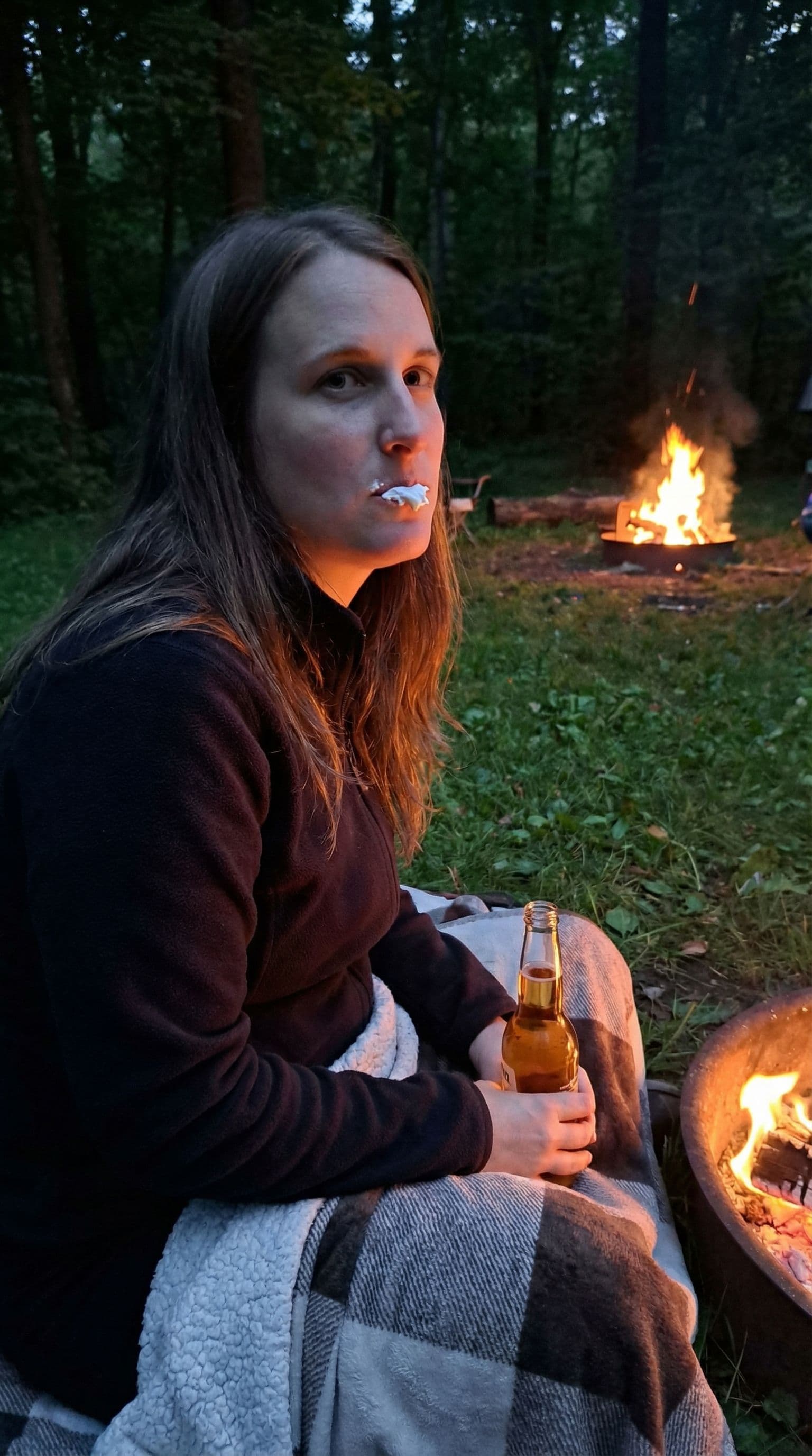 AI generated: 35 year old beauty in a camp by night, long dark blonde hair, around a fire, campsite, firepit, camp...