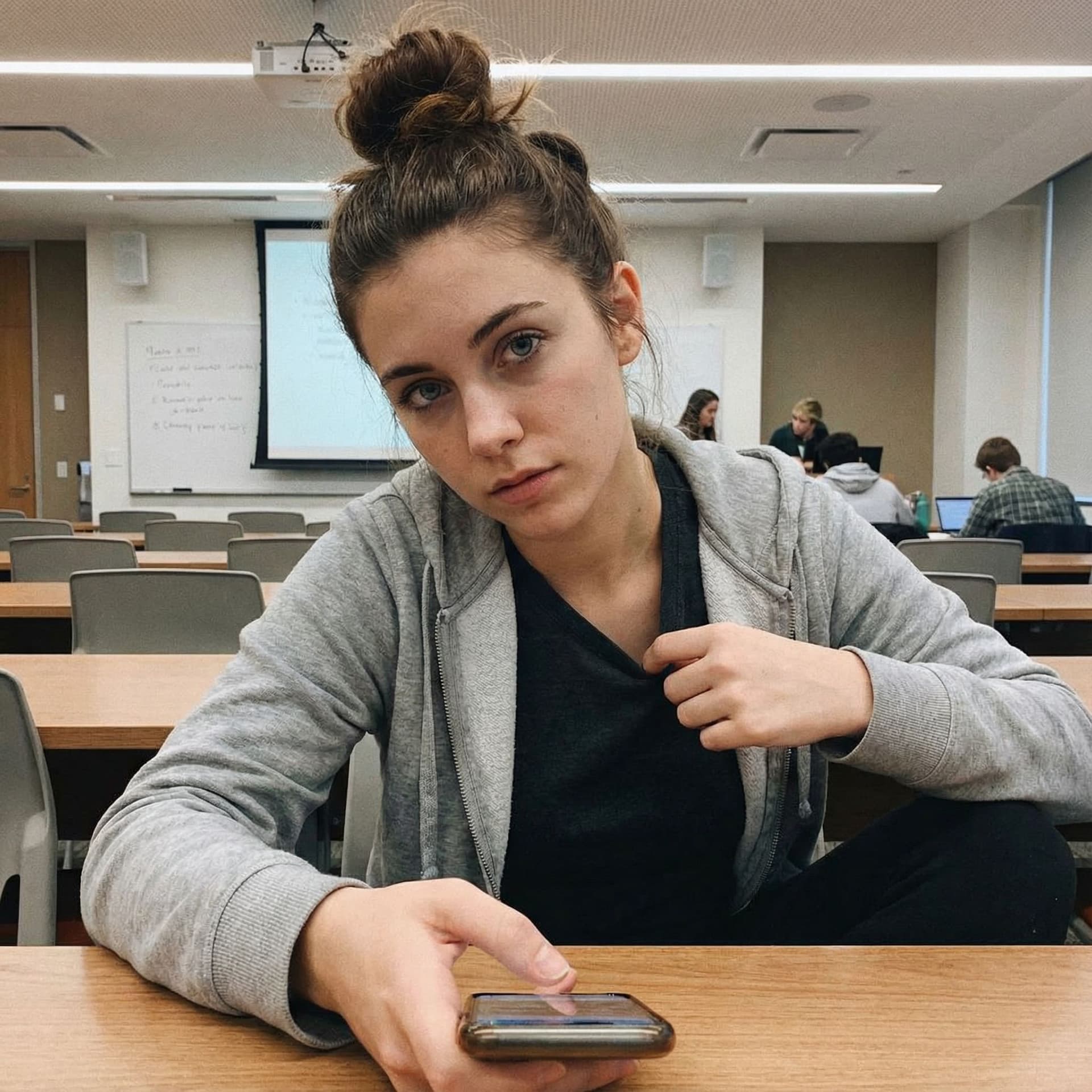 AI generated: (SORA)
A realistic smartphone-style photo of an adult woman (early twenties) sitting at a desk in a ...