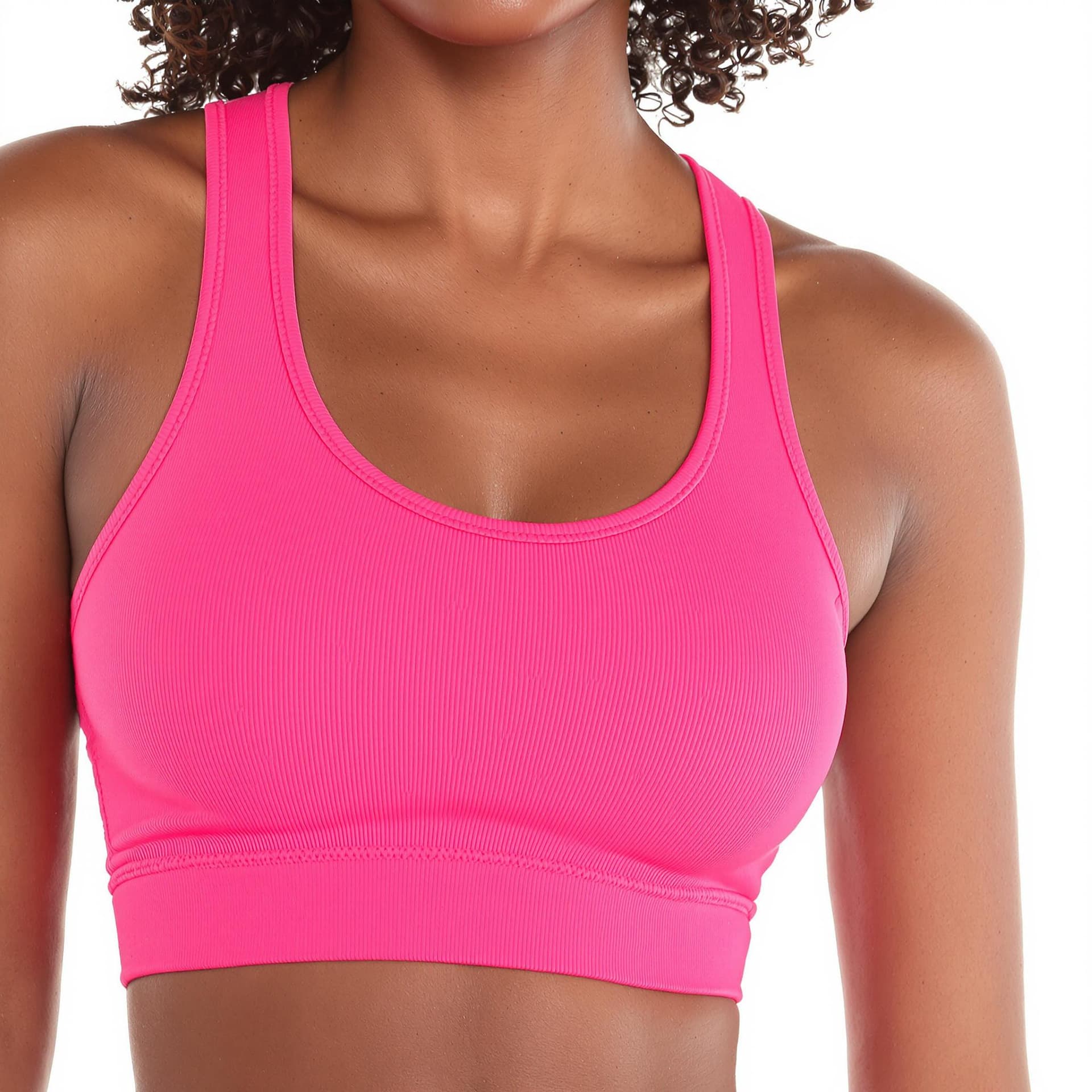 AI generated: a black woman wearing pink sports bra and matching leggings. The backdrop is white.
